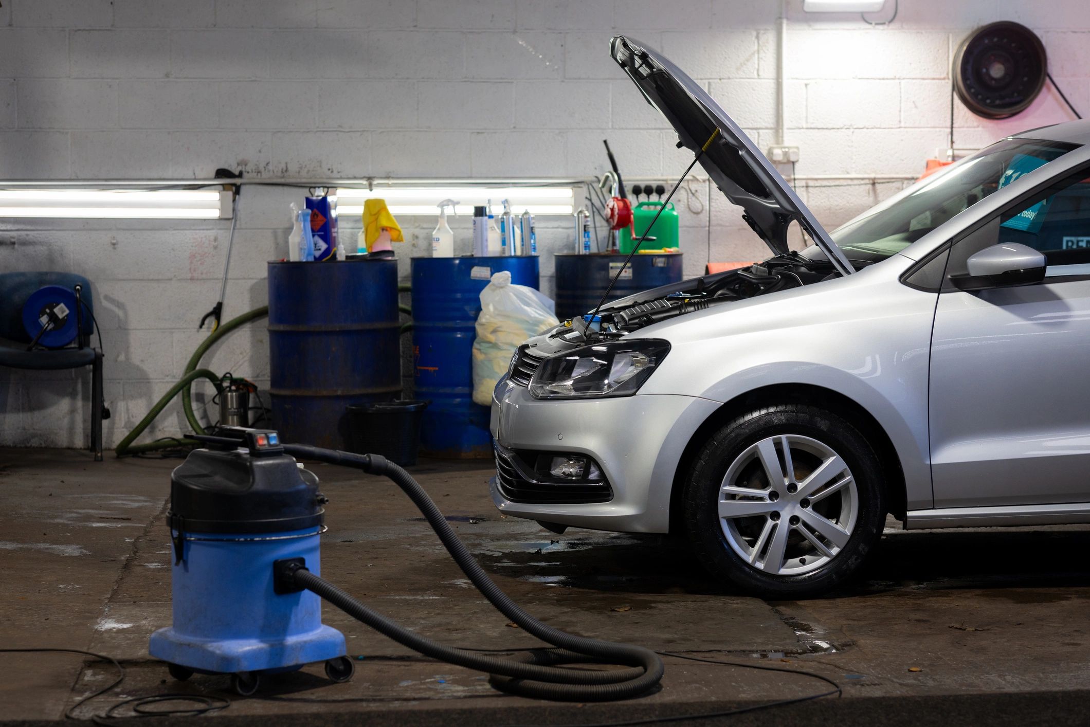 Vehicle being serviced in a repair garage representing used vehicle coverage