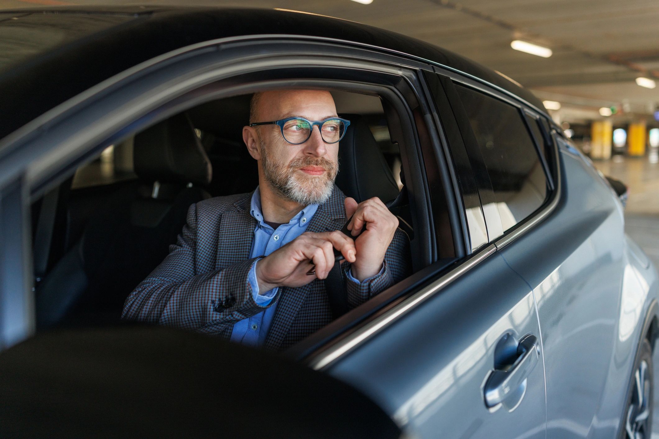 Driver seated in a vehicle, representing confidence and readiness