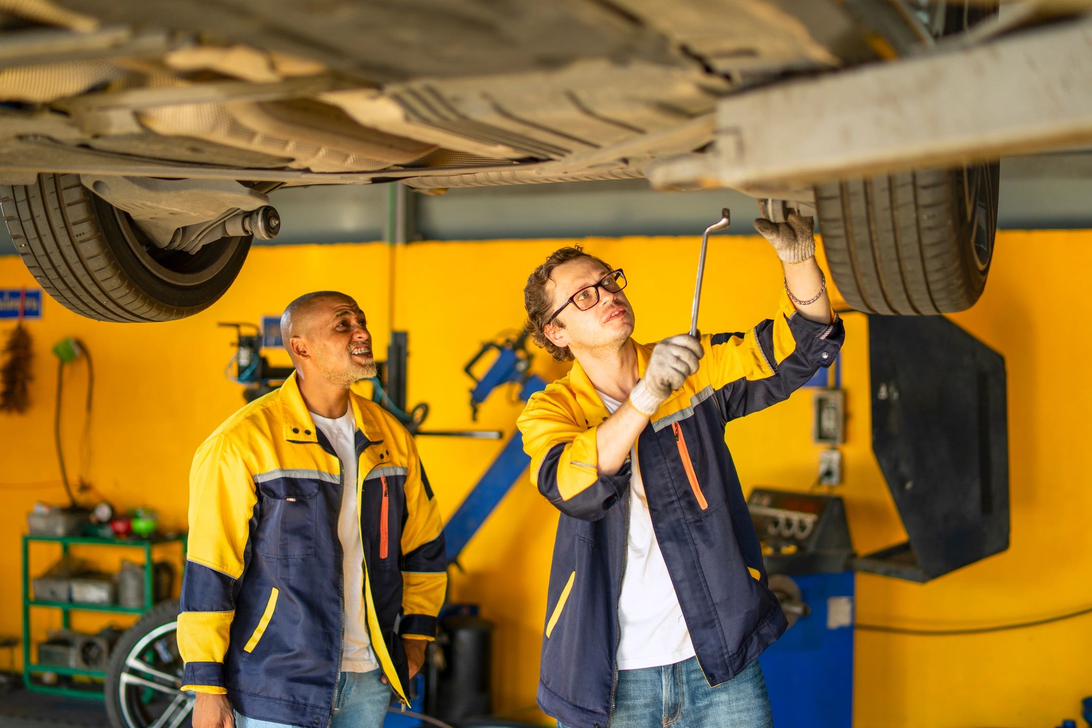 Mechanics inspecting a used vehicle
