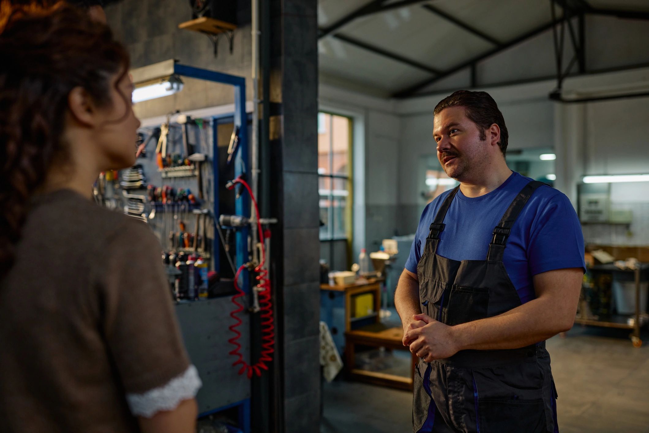 Mechanic speaking with a customer about vehicle repair needs